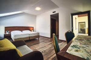 a bedroom with a bed and a chair at Hotel AB in Tychy
