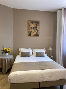 - une chambre avec un grand lit et une table dans l'établissement Villa d'Estelle, à Cannes