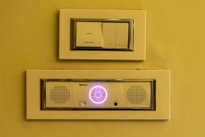 a television is attached to a wall with a mirror at Hotel Pratham in Solapur