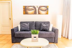 a living room with a couch and a table at Giramar Apartamentos Turisticos in Lagos