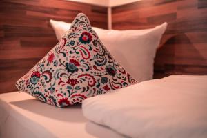 a pillow sitting on top of a bed at SSC Sport+Seminarcenter Radevormwald in Radevormwald +7 photos