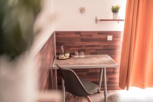 a table and a chair in a room at SSC Sport+Seminarcenter Radevormwald in Radevormwald