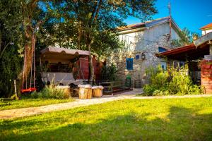 a house with a tent in the yard at Holiday Home Casa Bianca in Malinska