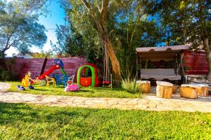 a childs play area with toys in the grass at Holiday Home Casa Bianca in Malinska