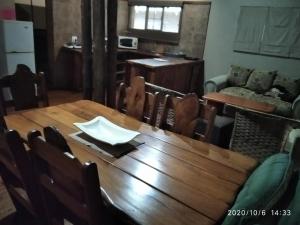 a wooden table with chairs and a dining room at Hanlin Lodge in Modimolle