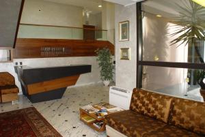 a living room with a couch and a table at Hotel Iris in Genoa