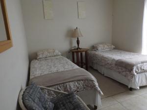 スティル・ベイにあるGrace Holiday Homeのベッド2台とランプが備わる部屋 +6枚の写真