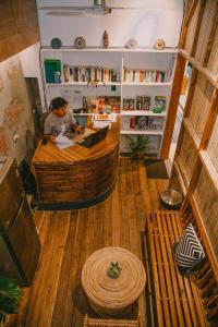a man sitting at a desk in a room at SANSE Boutique Hotel in El Nido