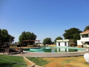a large pool with a playground in a yard at Top3 Lords Resort Bhavnagar in Bhavnagar