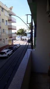a view of a street from a building with cars parked at Cheiro de Mar in Balneário Camboriú