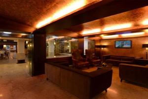 a lobby with a couch and chairs in a room at Top3 Lords Resort Bhavnagar in Bhavnagar
