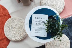 a plate with a book and a plant at Xandra's Maritime Suite in George Town