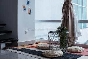 a room with a rug and a potted plant on the floor at Xandra's Maritime Suite in George Town