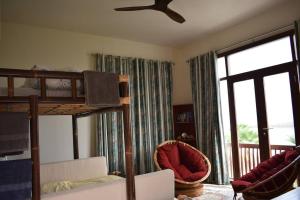 a bedroom with a bunk bed and a balcony at NomadTours Marina Apartment Jebel Sifah in As Sīfah