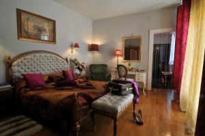 a bedroom with a bed and a chair in it at Villa Venus in Deva