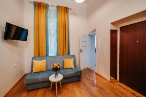 a living room with a couch and a table at ALPARI apartments in Krakow