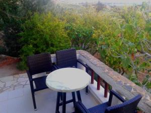 a table and chairs on a balcony with a view at Sunrise Apartments in Palekastron