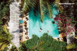 una vista aérea de una piscina con gente en ella en The Seles Boutique Hotel, en Matemwe