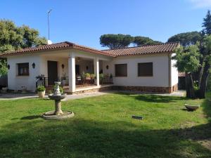 a small white house with a green yard at Casa en Parque Natural del Montseny. in Santa María de Palautordera