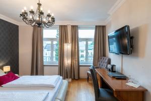 TV a/nebo společenská místnost v ubytování Altstadthotel Wolf-Dietrich