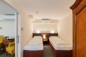 Rúm í herbergi á Altstadthotel Wolf-Dietrich