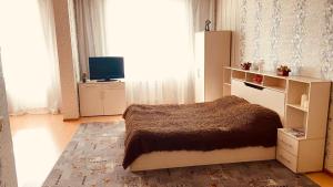 Tempat tidur dalam kamar di Apartment Sura Sport