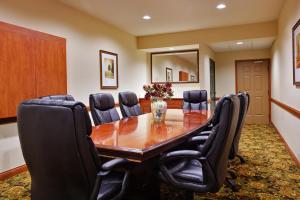 a conference room with a wooden table and black chairs at Country Inn & Suites by Radisson, Louisville South, KY in Shepherdsville