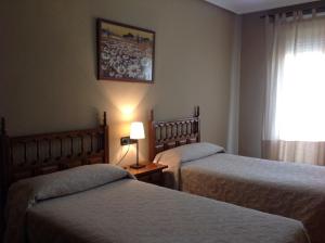 Posteľ alebo postele v izbe v ubytovaní Hostal Argentino