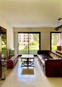 a living room with a leather couch and a table at Carlton Riviera in Cannes