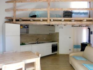 a kitchen with a loft bed in a room at Residence La Pineta in Budoni