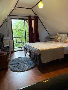 a bedroom with a bed in a tent with a window at Mer Riviere Self Catering Apartment in Beau Vallon