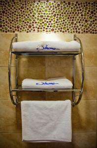 a towel rack with towels on it in a bathroom at Shuma in Dąbrowa Górnicza