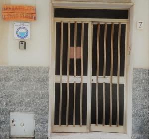 a door with bars on the side of a building at Il Tuo Letto Sullo Stretto in Reggio Calabria