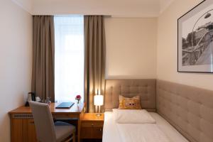 Rúm í herbergi á Altstadthotel Wolf-Dietrich