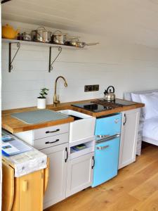 a kitchen with a sink and a stove at Castle Lodge in Sheriff Hutton