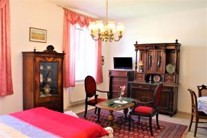 a bedroom with a bed and a table and a room with a bed at Apartmány PAPÍK in Nová Bystřice