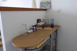 a counter in a kitchen with a wooden table at Studio Option face à la mer in Agon Coutainville
