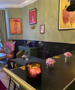 a restaurant with tables with candles and flowers on it at The White House Hotel in Newquay