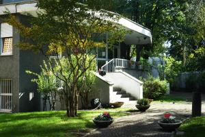 a house with a staircase in the yard at Hi! Ostello Milano in Milan