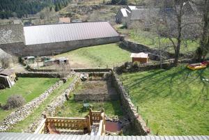 an aerial view of a farm with a field at La Belle Arverne in Albepierre-Bredons