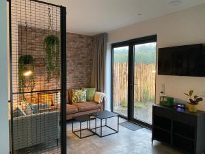 a living room with a couch and a tv at Guesthouse Scherp in Middelburg
