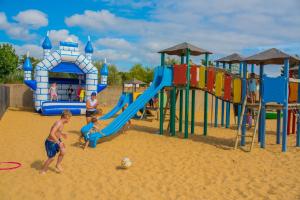 a group of kids playing on a playground at Mobile Homes by KelAir at Camping Sol a Go Go in Saint-Hilaire-de-Riez