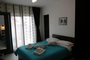 a bedroom with towels on a bed with a window at Cabana Transalpina in Ranca