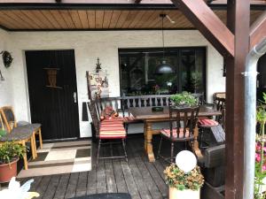 an outdoor patio with a wooden table and chairs at Ferienwohnung Wolf in Reichshof 