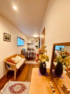 a living room with a couch and a table at 遥華-Haruka House in Kyoto