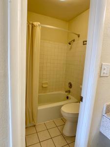 a bathroom with a tub and a toilet and a sink at LA VISTA INN in Port Richey