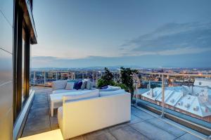 a balcony with couches and a view of the city at Les Immeubles Charlevoix - Le 760707 in Quebec City