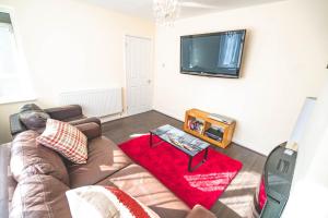 a living room with a couch and a flat screen tv at Modern 3 Bed House in Sidcup, Parking in Sidcup