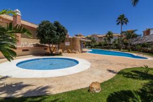 a swimming pool in the yard of a house at Zahara Sol Villas y Apartamentos by QHotels in Zahara de los Atunes