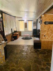 a living room with a table in the middle of a room at Къща за гости Голямо Дряново in Golyamo Dryanovo